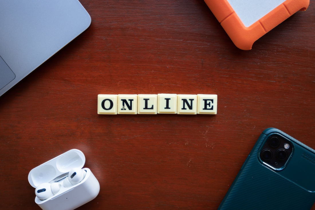 the word online spelled with scrabble letters on a wooden table